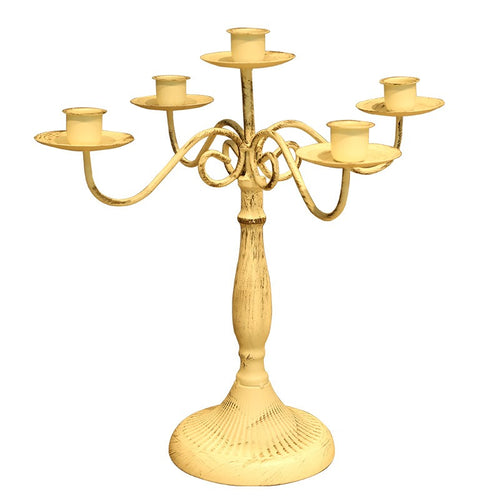Metal branch candle holder with taper candles on a dining table