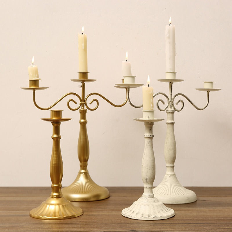Metal branch candle holder with taper candles on a dining table