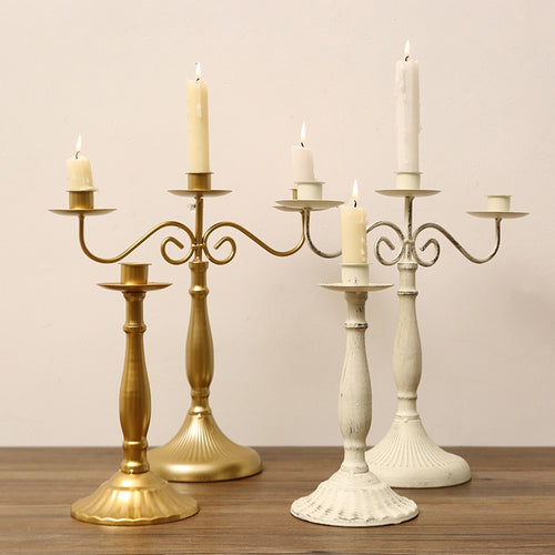 Metal branch candle holder with taper candles on a dining table