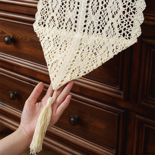 Beige crochet table runner on a wooden table